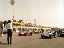 Tony Brooks (No. 30) sits on the front of the grid with Jack Brabham
