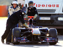 Toro Rosso mechanics take precautions wheeling Sebastien Buemi's KERS-equipped car back to the pits
