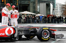 Lewis Hamilton and Jenson Button examine the new MP4-26