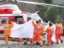 Italian paramedics use a sheet to cover the rescue of Robert Kubica