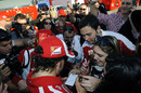 Fernando Alonso is mobbed by fans at the end of the day