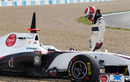 A rueful Kamui Kobayashi looks at his Sauber as it sits in the gravel