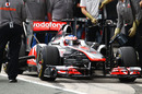 Jenson Button gets attention in the pits