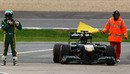 Frustration for Heikki Kovalainen as his Lotus stops at the entrance to the pit lane