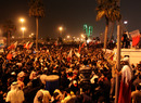 Bahraini anti-government protesters wave flags in a demonstration