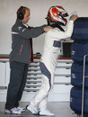 Kamui Kobayashi receives a back rub in the Sauber garage