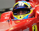Fernando Alonso keeps a close eye on the timing screens