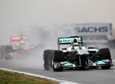 Nico Rosberg leads Lewis Hamilton out of the pits