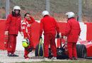 Felipe Massa waits for his Ferrari to be lifted out of the gravel