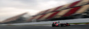 Lewis Hamilton flies past an empty grandstand