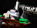 Adrian Sutil cranks on the steering lock in the Force India