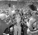 Jim Clark celebrates victory on US soil after winning the Indianapolis 500 at his third attempt with Lotus