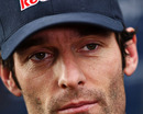 Mark Webber talks to the press in the paddock
