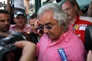 Flavio Briatore is mobbed by the media as he leaves a meeting at the Automobile Club de Monaco