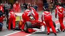 Felipe Massa's Ferrari is wheeled back in to the garage