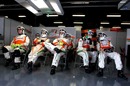 Force India mechanics wait in the garage for their next pit stop