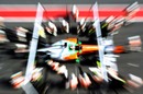 Force India go to work on Paul Di Resta's car in the pits