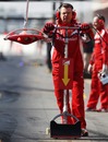 Ferrari's front jack man waits in the pit lane