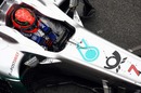 Michael Schumacher makes adjustments on his steering wheel