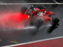 Fernando Alonso splashes down the pit lane at the Circuit de Catalunya