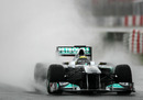 Nico Rosberg cuts a path through the spray