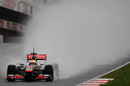 Lewis Hamilton leaves a huge trail of spray in his wake coming down the pit straight