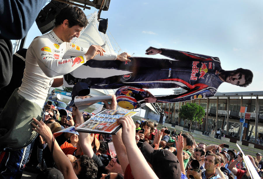 Mark Webber signs a life-size cutout of himself as part of the build-up to the Australian Grand Prix