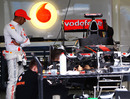 Lewis Hamilton watches on as preparations are made to his McLaren