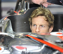 Jenson Button tries out his McLaren cockpit for size