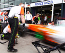 Force India mechanics practice a pit stop on Friday morning ahead of the first practice session