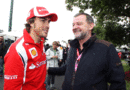 Fernando Alonso talks to ex-Minardi boss Paul Stoddart in the paddock