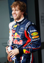 Sebastian Vettel smiles for the cameras after taking pole position