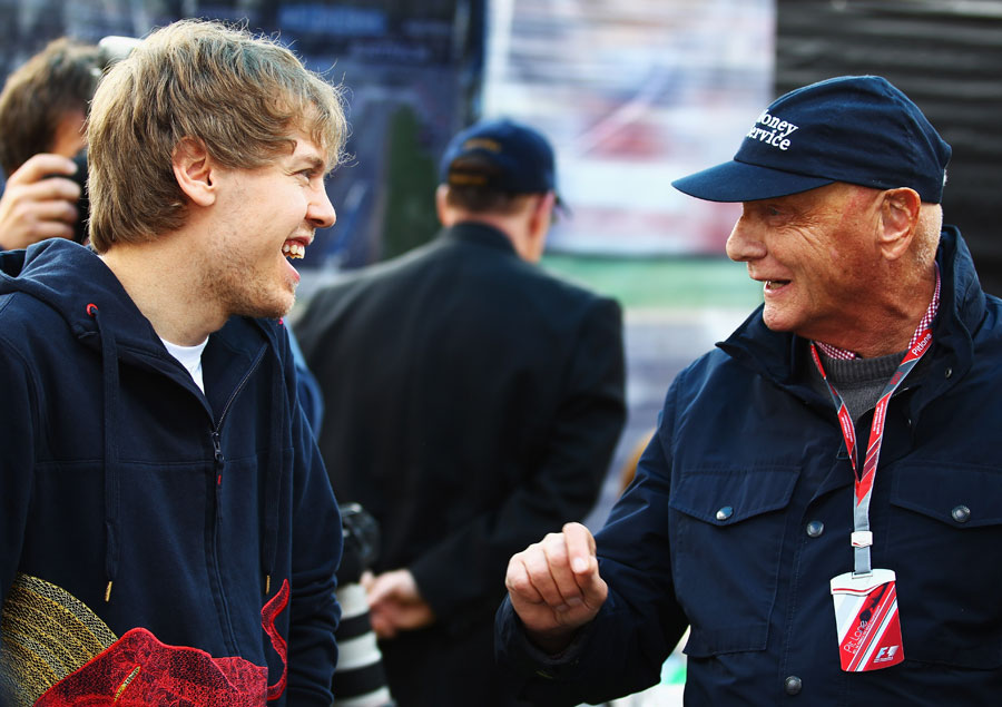 Sebastian Vettel shares a joke with Niki Lauda
