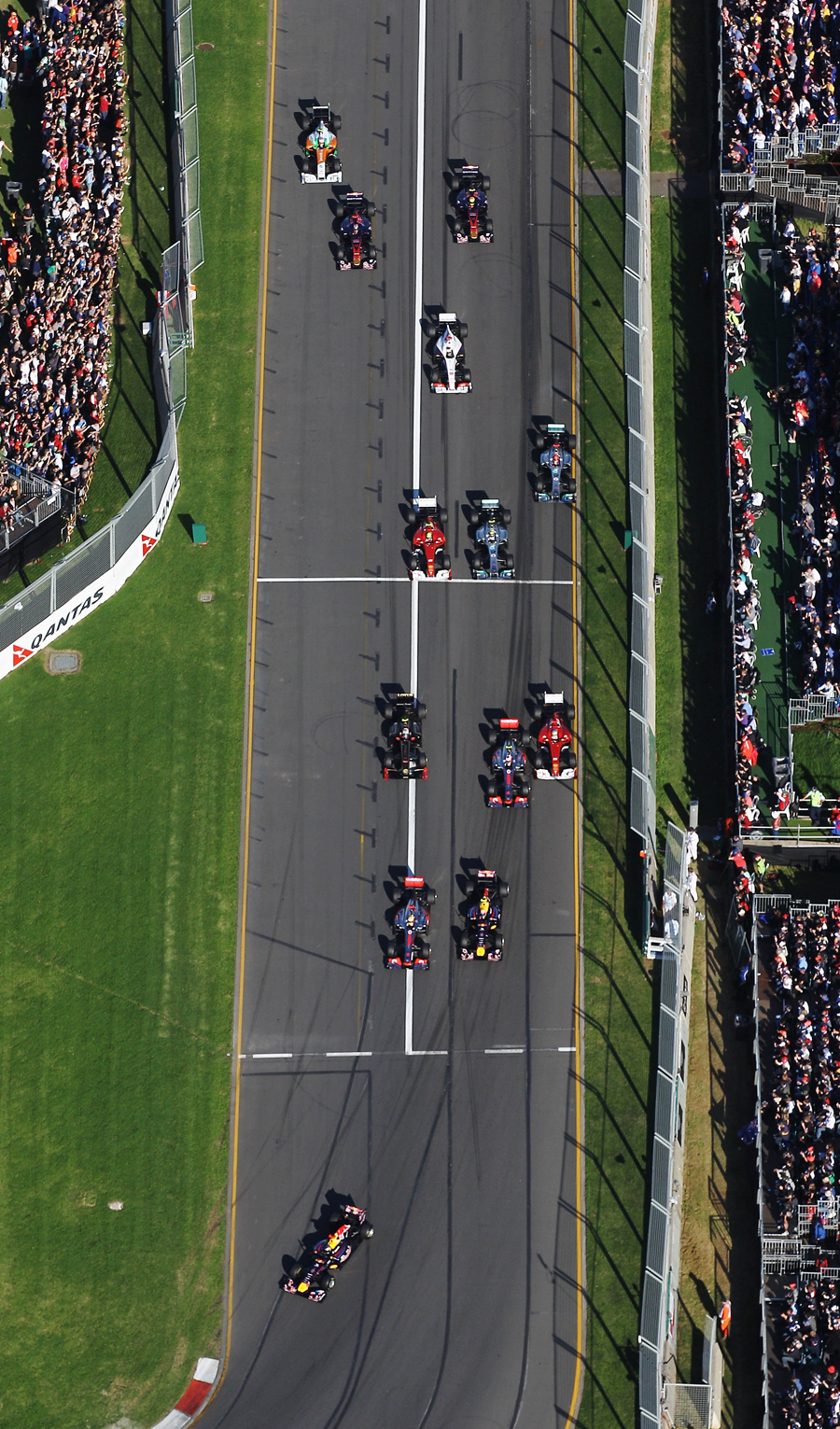 Sebastian Vettel leads the field as Fernando Alonso gets squeezed wide