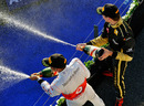 Second-place Lewis Hamilton and third-placed Vitaly Petrov spray the champagne