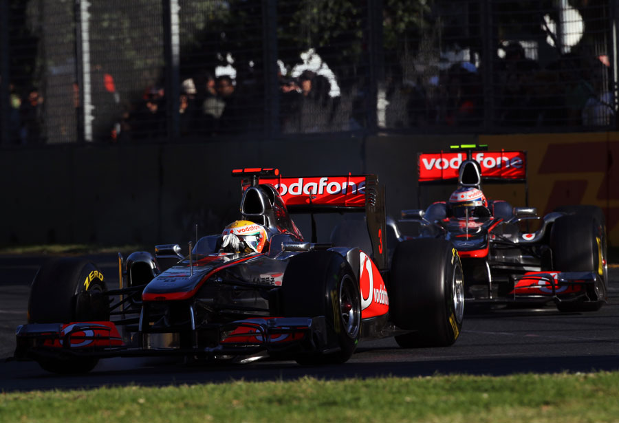 The McLarens of Jenson Button and Lewis Hamilton run nose-to-tail through turn three