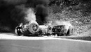 Willy Mairesse's burning Ferrari after his collision with Trevor Taylor's Lotus
