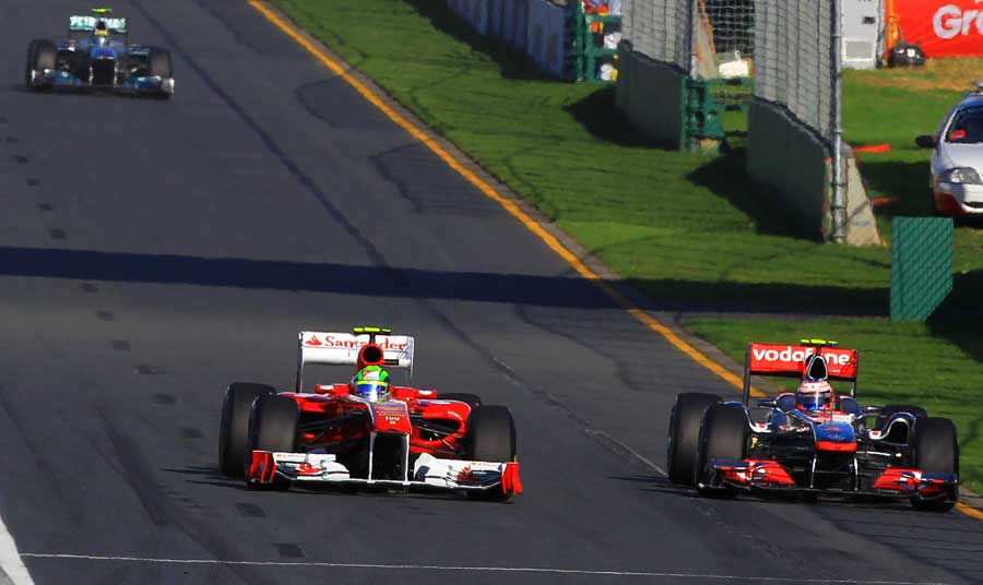 Jenson Button tries to go round the outside of Felipe Massa