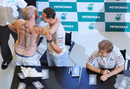 Michael Schumacher is hugged by an overenthusiastic fan during a meet-the-public session ahead of the Malaysian Grand Prix