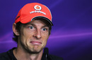 Jenson Button responds to a question in the press conference