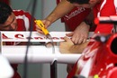 Ferrari mechanics make some adjustments to its DRS system