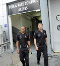 Lewis Hamilton walks back from the FIA stewards' room after being penalised for blocking Fernando Alonso