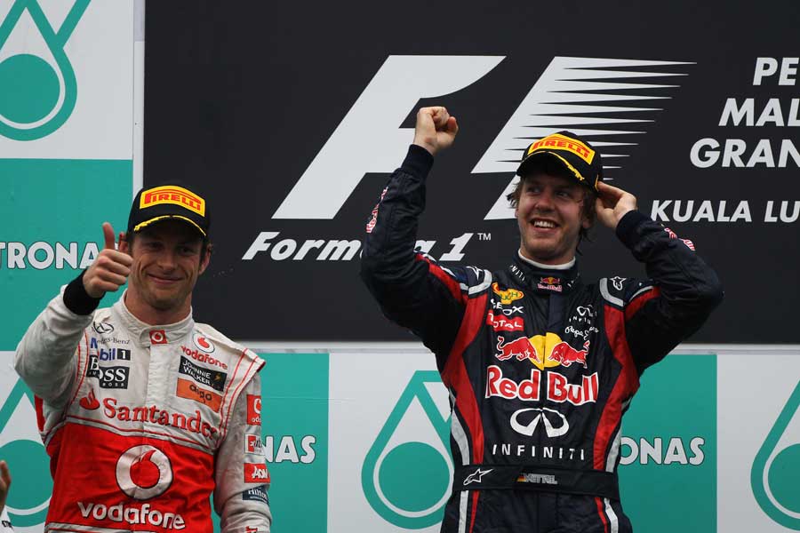Sebastian Vettel and Jenson Button celebrate on the podium