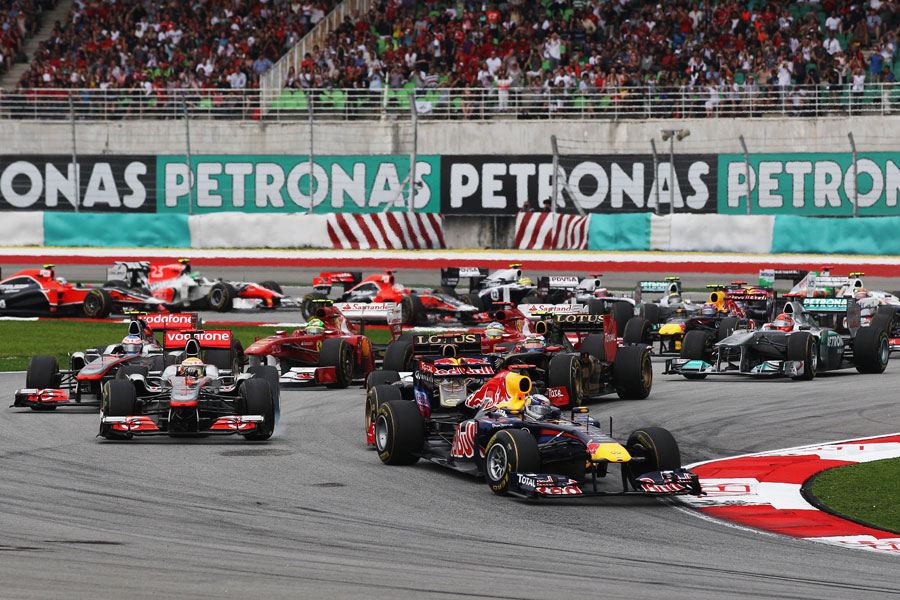 Sebastian Vettel leads the field through the first two corners