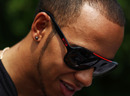 Lewis Hamilton relaxes in the paddock