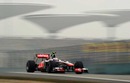Jenson Button blasts throught the haze in the McLaren