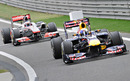 Sebastian Vettel leads Jenson Button back in to the pit lane after securing pole