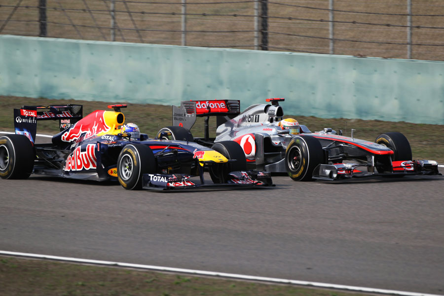 Lewis Hamilton is passed by Sebastian Vettel early in the race