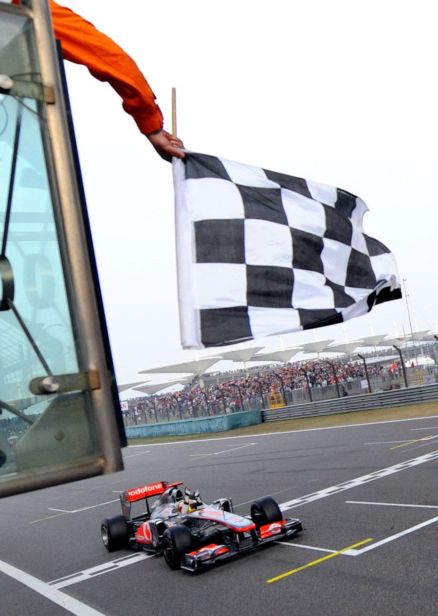 Lewis Hamilton takes the chequered flag to win