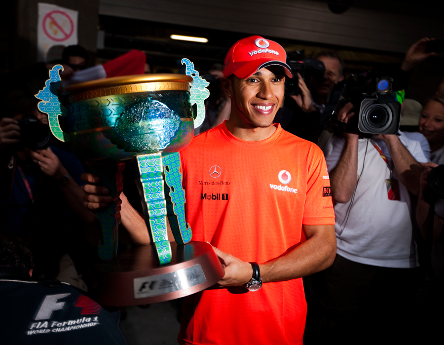 Lewis Hamilton poses with the trophy